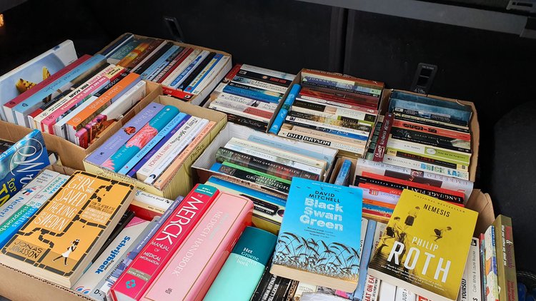 boxes full of books in a car boot