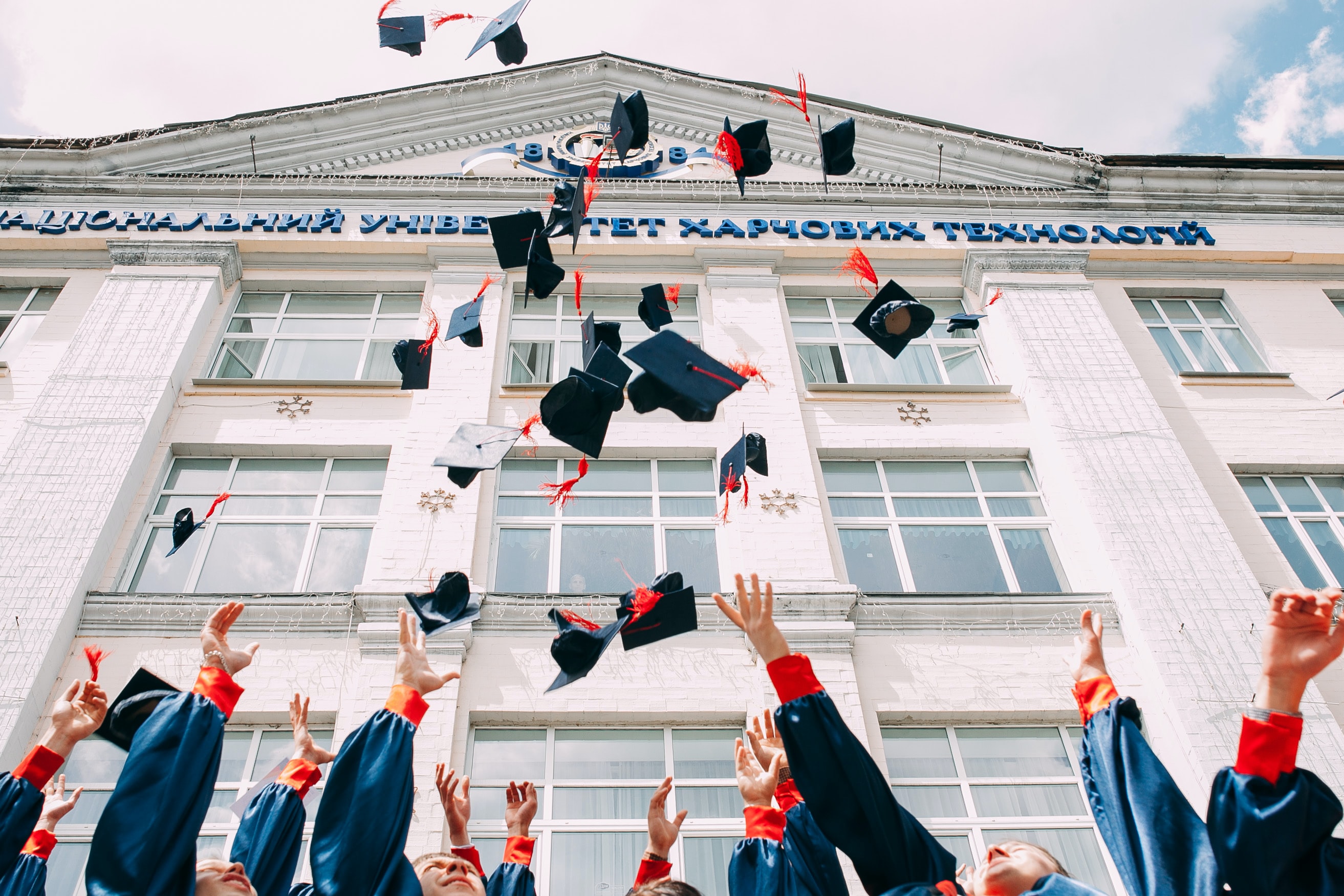 students throwing academic caps into the air